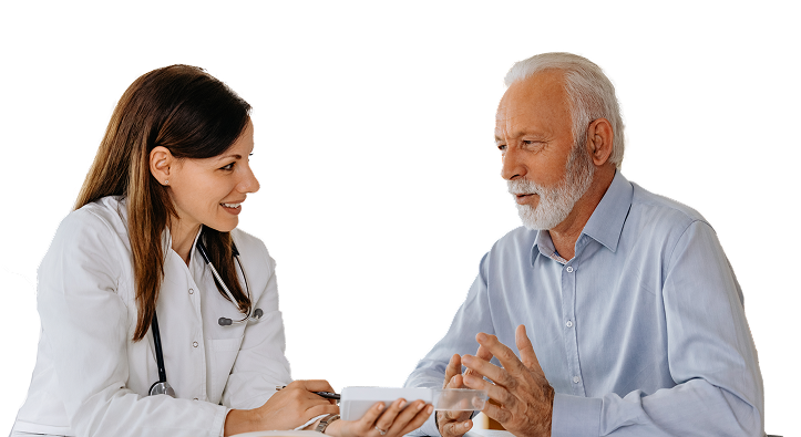 A healthcare provider discusses treatment options with a seated older male patient.
