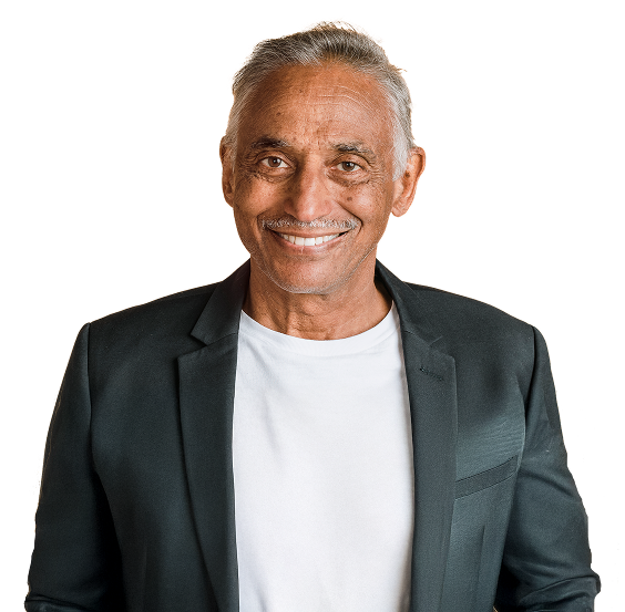 A smiling older man with grey hair, wearing a blazer.