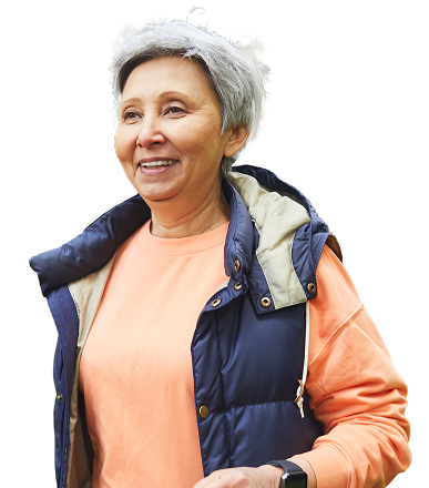 A woman with a puffer vest smiles.